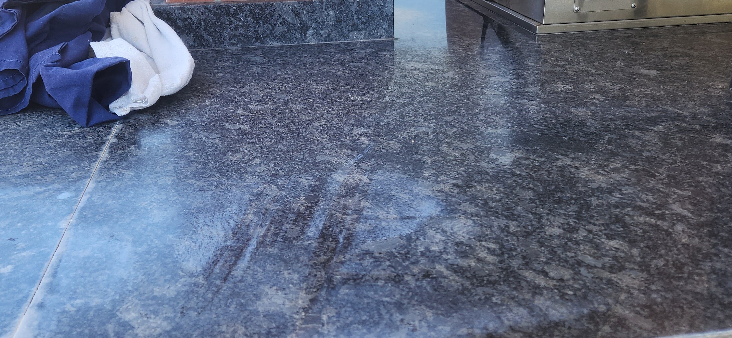 Weathered outdoor granite countertop prior to cleaning and resealing
