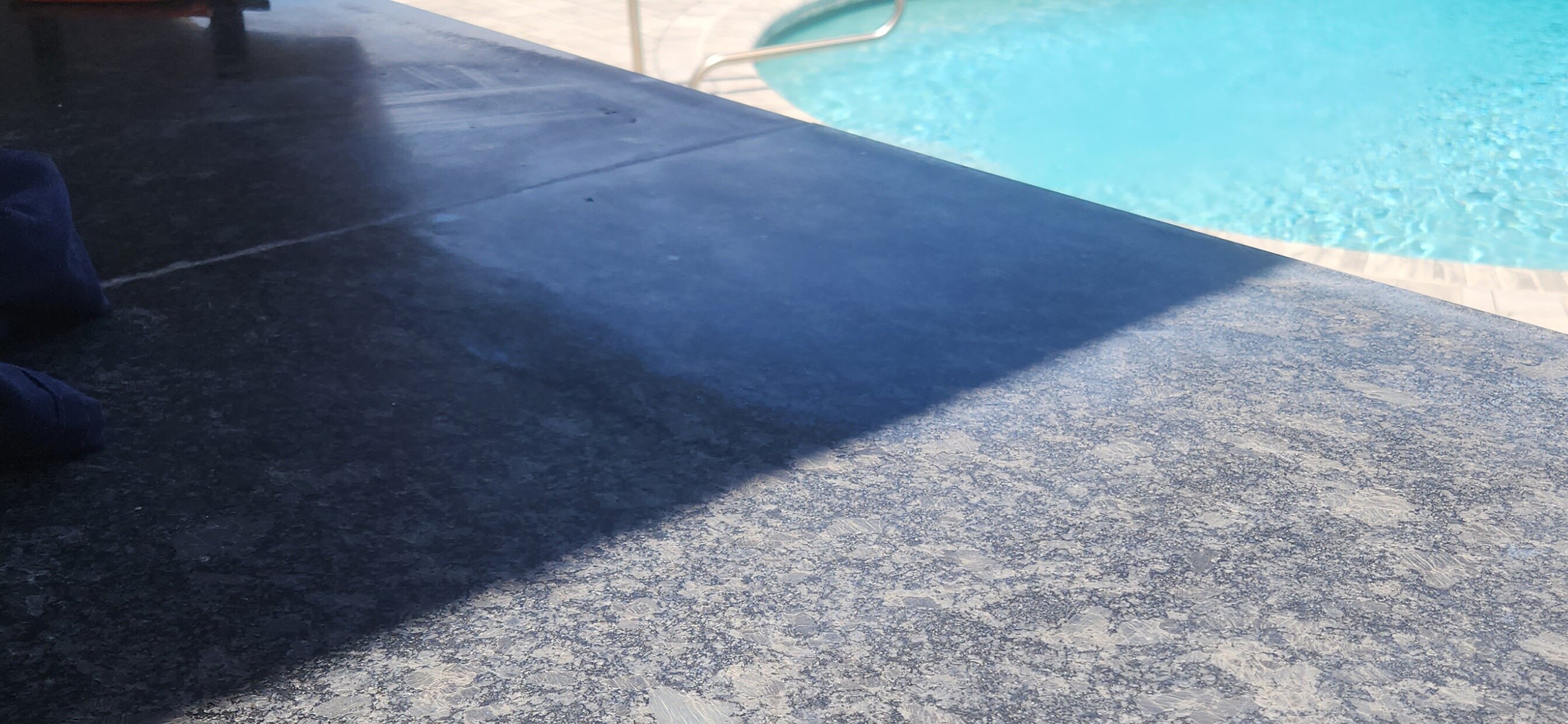 Close up of dull, unsealed granite surface on patio kitchen