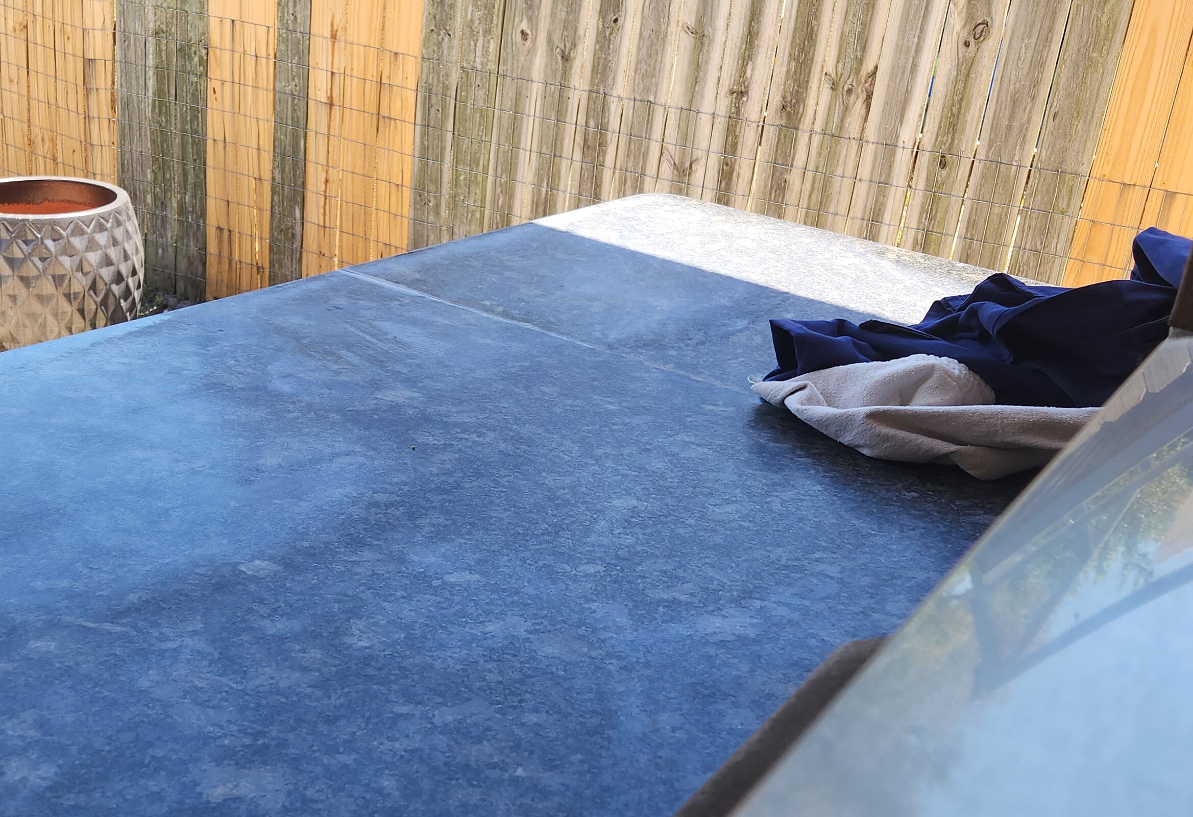 Patio bar surface showing wear from sun and rain exposure