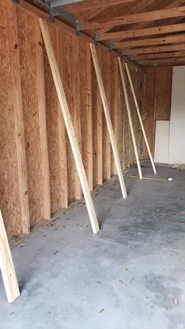 Unorganized garage storage space prior to custom shelving installation
