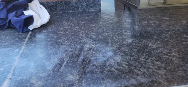 Weathered outdoor granite countertop prior to cleaning and resealing
