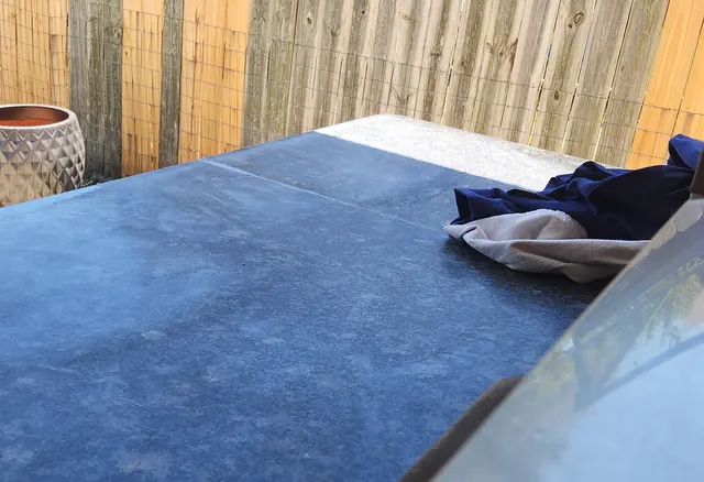 Patio bar surface showing wear from sun and rain exposure